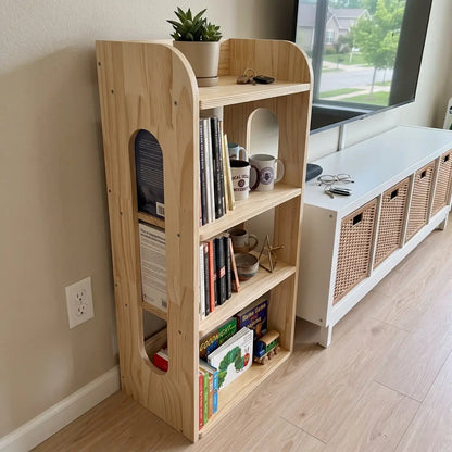 Unfinished pine narrow shelving unit beside a TV console in a living room