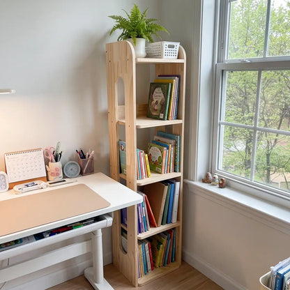 Slim solid pine storage shelf beside a kids study desk and window